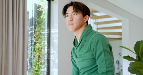 Man Contemplating in Modern Home with Natural Light