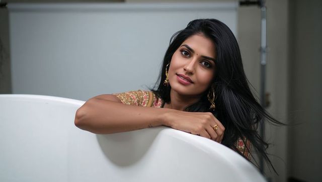 Elegant woman leaning on bathtub in minimalist bathroom