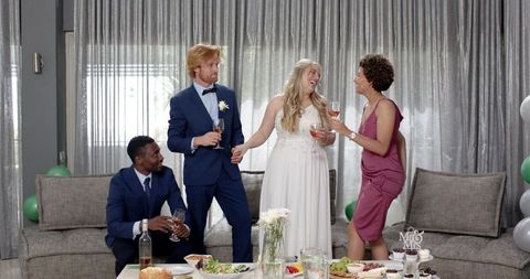 Joyful Wedding Toast with Multicultural Friends in Living Room