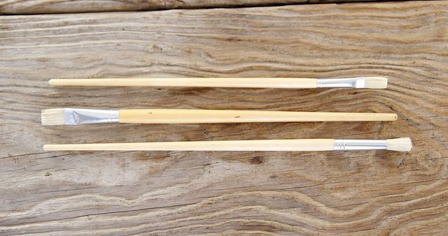 Variety of Paintbrushes on Wooden Surface - Download Free Stock Images Pikwizard.com