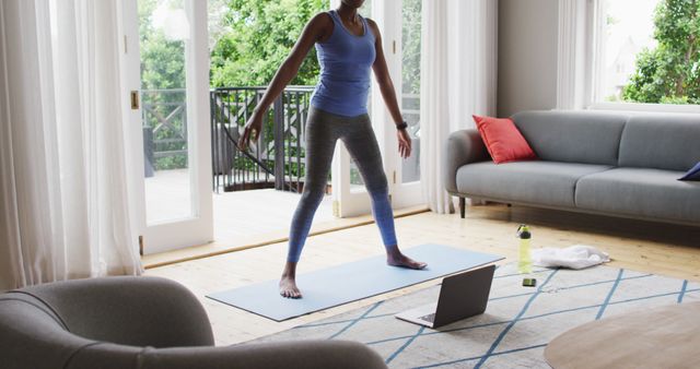 Woman Practicing Yoga at Home in Living Room with Laptop - Download Free Stock Images Pikwizard.com