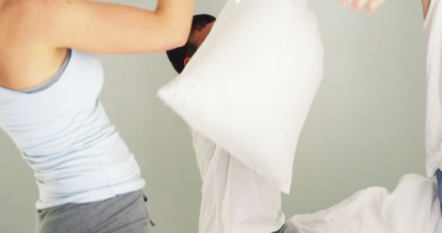 Friends Enjoying Playful Pillow Fight in Bedroom - Download Free Stock Images Pikwizard.com