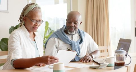 Senior African American Couple Reviewing Finances Over Coffee