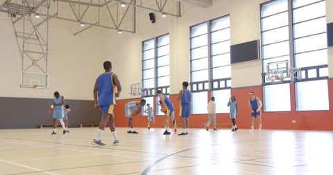 Team Basketball Practice in Contemporary Indoor Gym