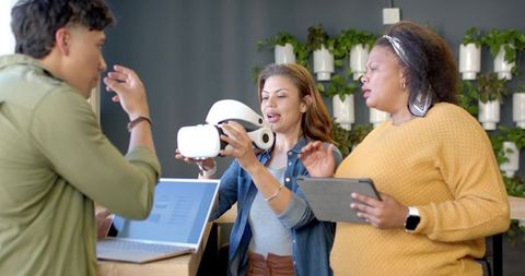 Testing vr headset with diverse team at modern office counter for collaboration