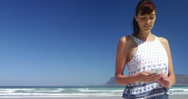 Young Woman Using Smartphone on Beach by Ocean - Download Free Stock Images Pikwizard.com