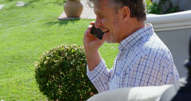 Smiling Elderly Man on Phone Call While Enjoying Sunny Day Outdoors - Download Free Stock Images Pikwizard.com
