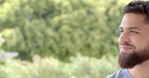 Contemplative Man Relaxing Outdoors in Nature