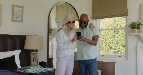 Couple Preparing Luggage Together in Bright Bedroom