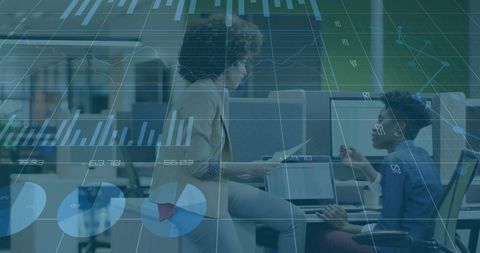 Professional women discussing data visualization and analytics in modern open-plan office