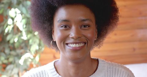 African american woman smiling at home with natural afro hairstyle