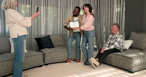 Celebrating achievement in group therapy session with certificate