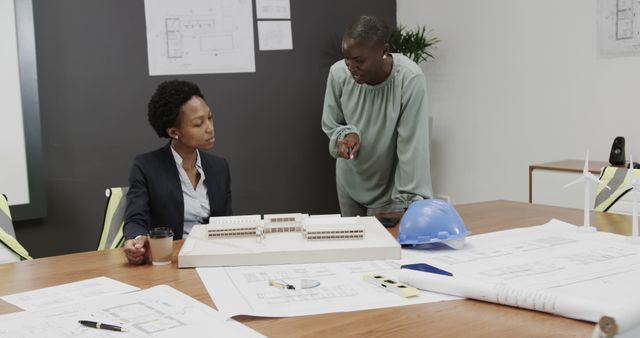 Architects Discussing Building Plans in Office Conference Room - Download Free Stock Images Pikwizard.com