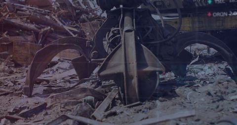 Heavy-duty claw machine in operation at industrial scrap site