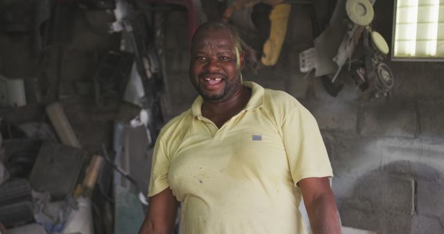 Mechanic in a Work Uniform Smiling in Garage - Download Free Stock Images Pikwizard.com