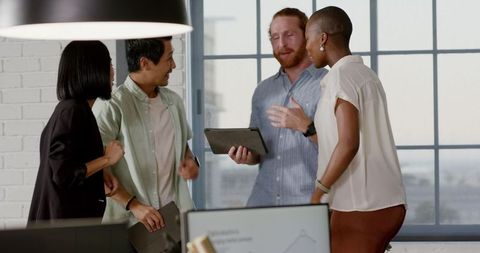 Diverse Colleagues Celebrating Success in Office Setting