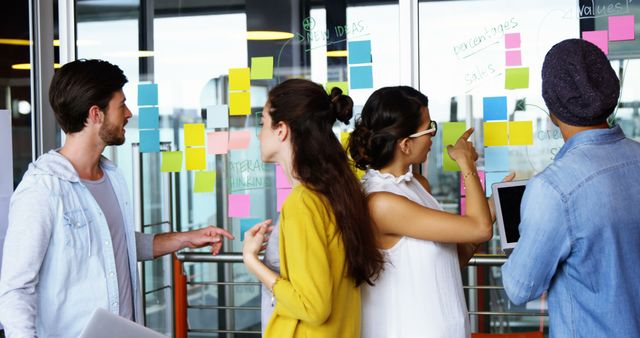 Group of Young Professionals Brainstorming in Office With Sticky Notes - Download Free Stock Images Pikwizard.com