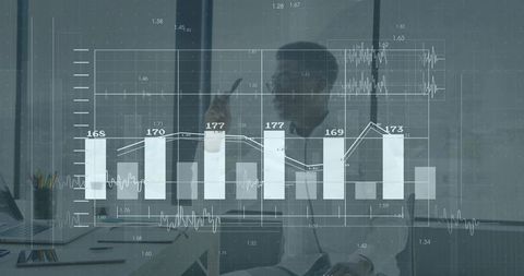 Businessman Analyzing Financial Data with Interactive Charts Overlay in Modern Office
