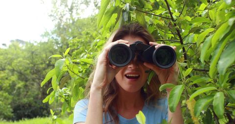 Woman Exploring Nature with Binoculars in Lush Greenery - Download Free Stock Images Pikwizard.com