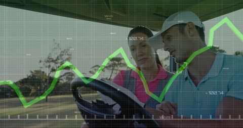 Golfers Analyzing Data on Course in Moving Golf Cart
