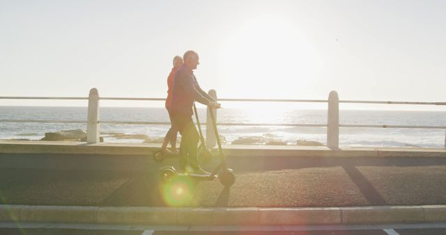 Senior Couple Riding Electric Scooters by Ocean at Sunset - Download Free Stock Images Pikwizard.com