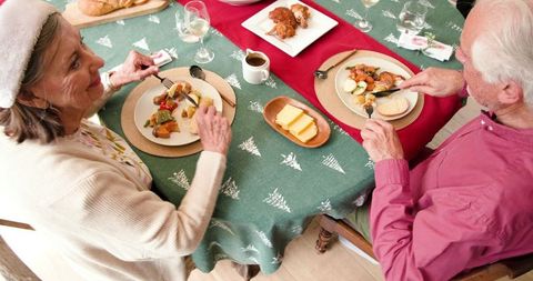 Senior Couple Enjoying Festive Christmas Meal Together at Home