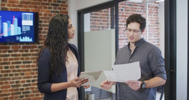 Colleagues Collaborating in Modern Office with Brick Walls and Data Charts - Download Free Stock Images Pikwizard.com