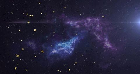 Glowing purple-blue nebula stretching across deep starfield with gold confetti and lens flare