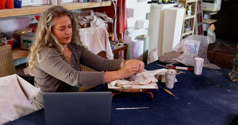 Focused Artistry: Woman Creating Pottery in Home Studio