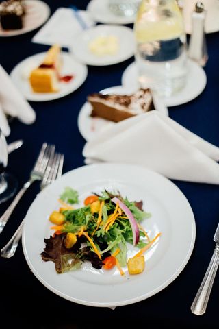 Elegant Wedding Dinner Salad on Navy Tablecloth with Croutons, Cherry Tomatoes, Dessert