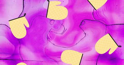 Yellow oven gloves on vibrant pink abstract background