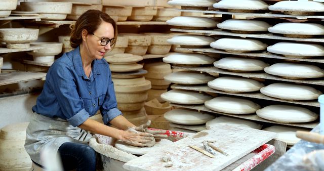Woman Creating Pottery in Art Studio Surrounded by Finished Works - Download Free Stock Images Pikwizard.com