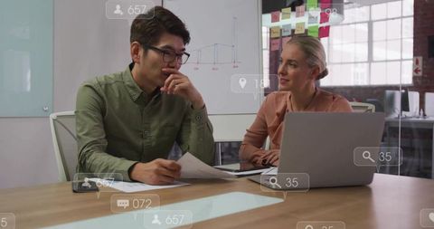 Collaborative strategy meeting reviewing analytics and growth plans in open-plan office