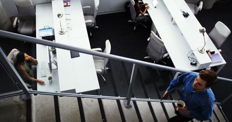 Business Professional Walking Up Office Stairs with Coffee