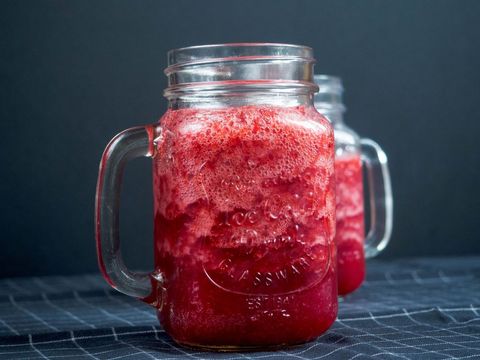 Refreshing strawberry smoothie in glass mason jars
