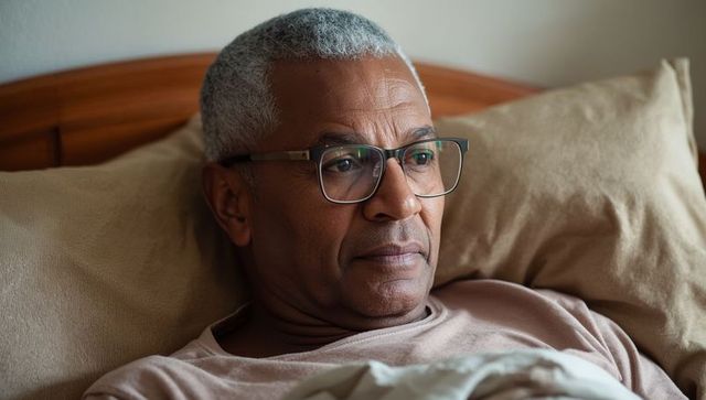 Senior Man Relaxing in Bed with Tranquil Expression