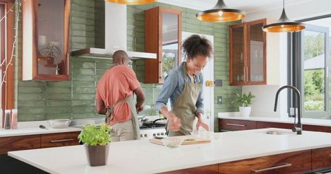 Happy couple cooking together in modern kitchen environment