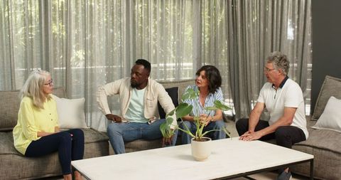 Diverse colleagues chatting in modern office lounge