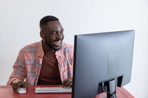 Smiling middle-aged man working at modern office desk