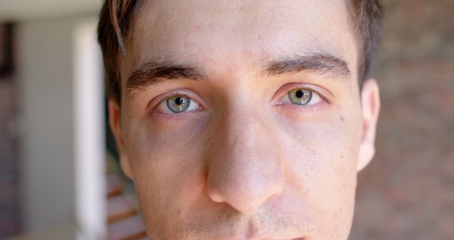 Close-Up of Young Man's Face with Blue Eyes and Serious Expression - Download Free Stock Images Pikwizard.com