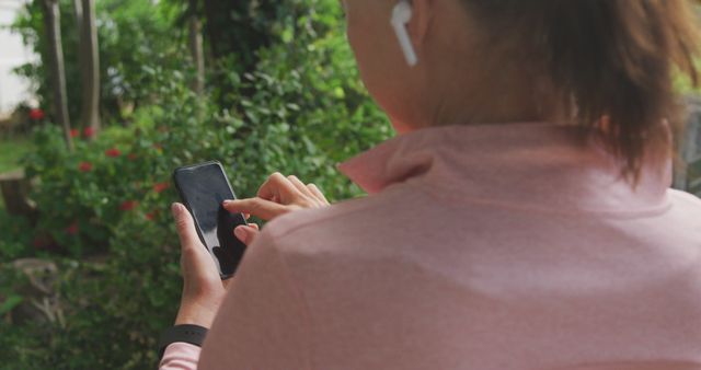 Woman Using Smartphone with Wireless Earbuds Outdoors - Download Free Stock Images Pikwizard.com