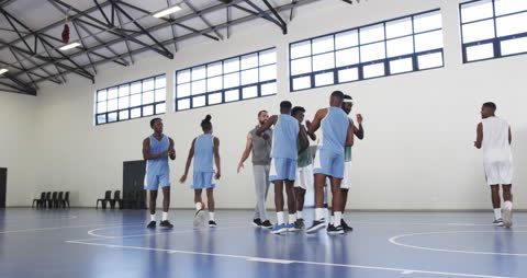 Basketball Team Huddling with Coach for Strategy Session