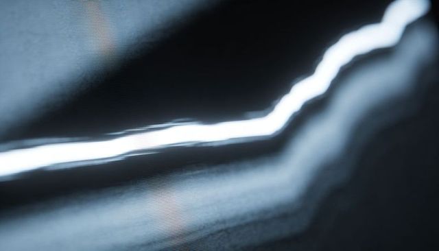Glowing jagged light streak cutting across bluish-gray scanline abstract tech background