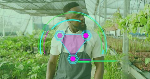 Horticulturist with Futuristic Interface in Greenhouse