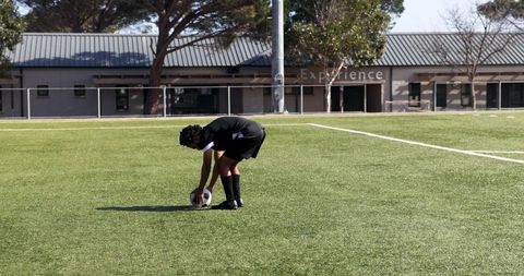 Soccer Player Preparing for Free Kick on Sunny Field