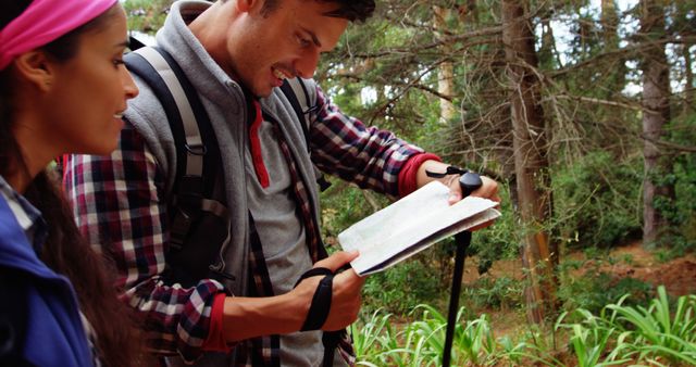 Young hikers navigating trail with map in forest - Download Free Stock Images Pikwizard.com