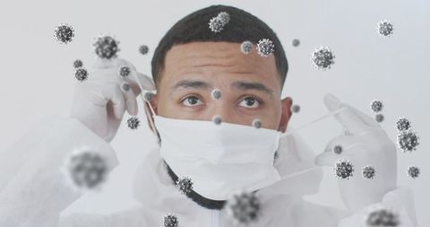 Scientist in protective gear adjusting mask in contaminated environment