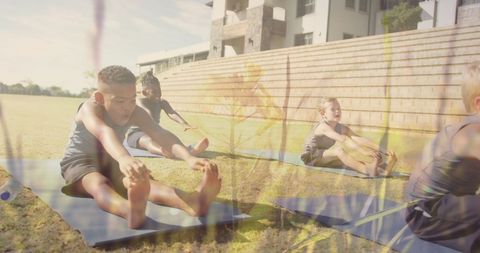 Diverse Schoolboys Stretching in Outdoor Yoga Class