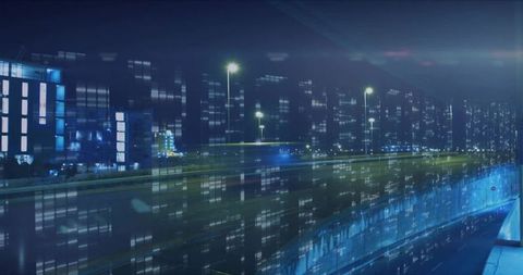 Elevated highway carrying blue light trails and reflecting city lights on glass facades