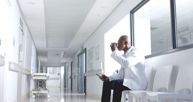 Doctor Taking Break in Hospital Corridor with Coffee and Tablet - Download Free Stock Images Pikwizard.com